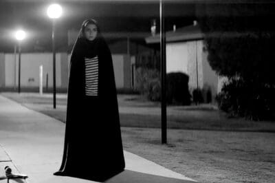 A GIRL WALKS HOME ALONE AT NIGHT